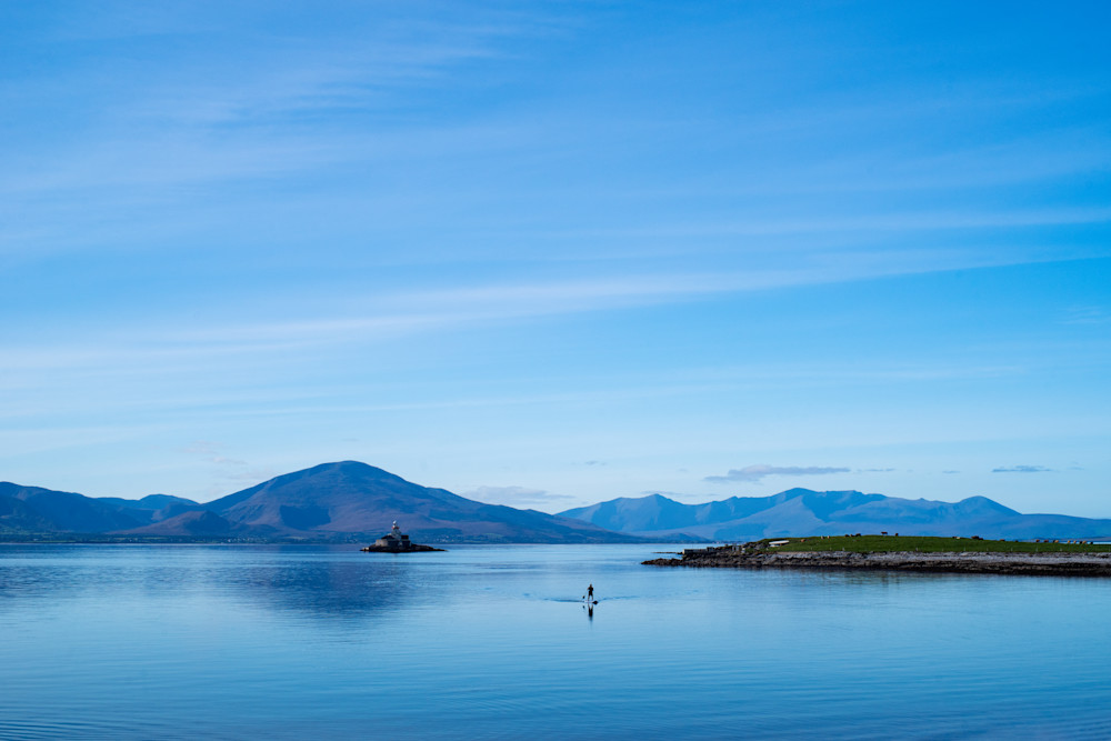 Fine Art Print of a paddle boarder on Tralee bay near the Fenit Lighthouse, County Kerry, Ireland