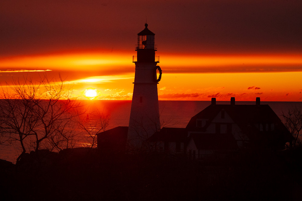 Winter sunrise over a Maine Lighthouse.