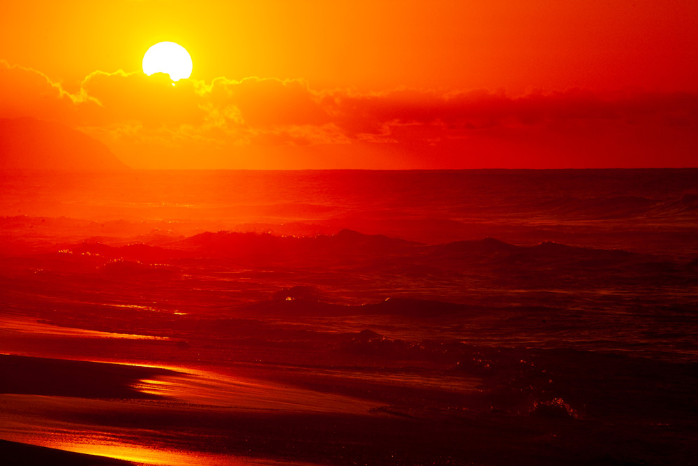 The sun sets on Sunset Beach, Oahu, Hawaii