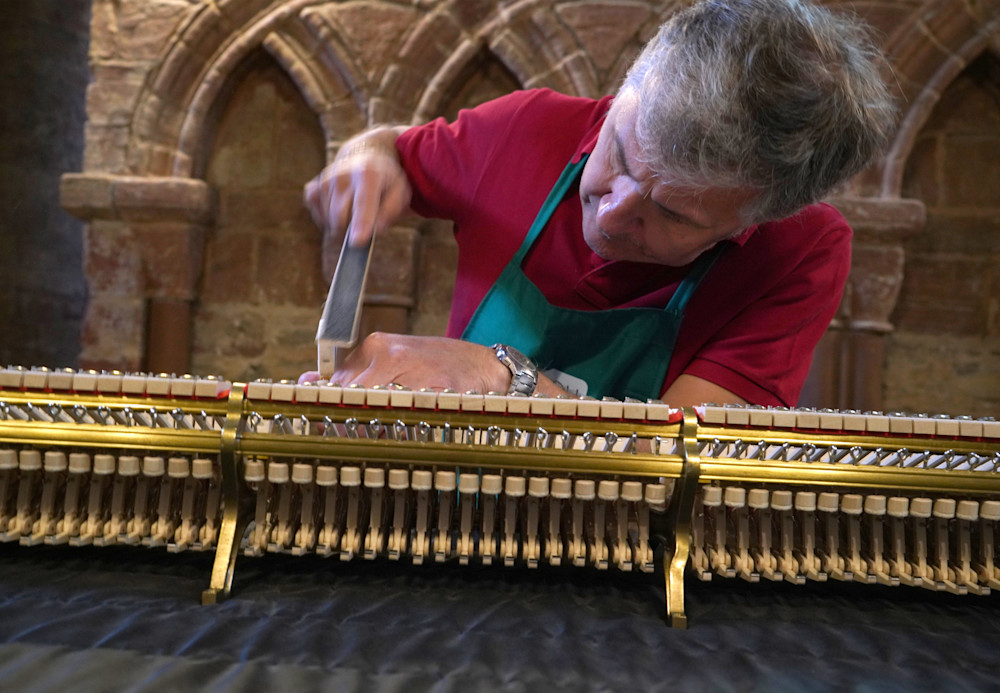 A piano tuner tunes a Steinway piano in the Magnus Cathedral in Kirkwall Scotland
Every Steinay has it’s own soul.  The great piano tuners first listen.  The piano tells the tuner what is needed.  Most often the tuning  involves increase the tensio