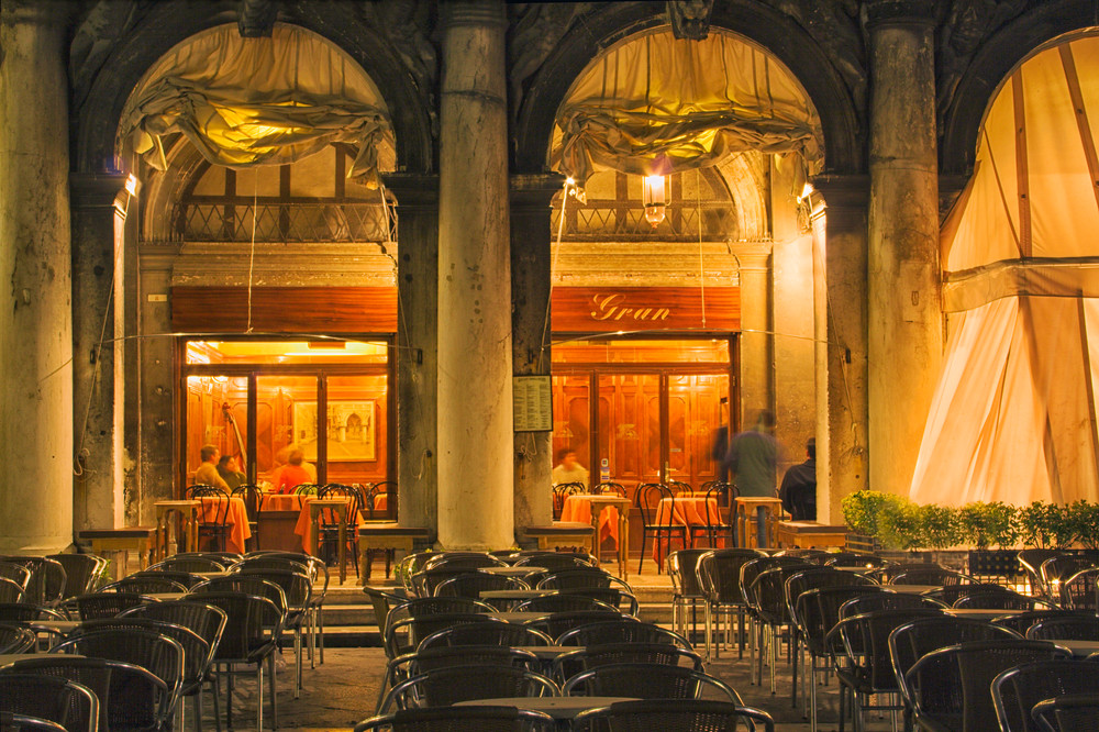 Chairs and cafe at night in Venice, Italy 