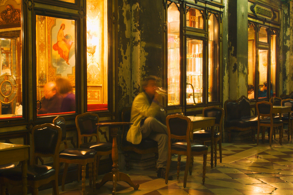 Night view of a man smoking at Cafe Florian, Piazzo San Marco, Venice, Italy 