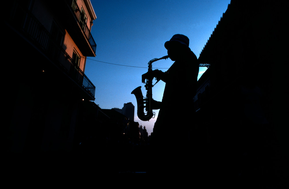French Quarter street musician plays his sax for spare change in New Orleans, Louisiana.