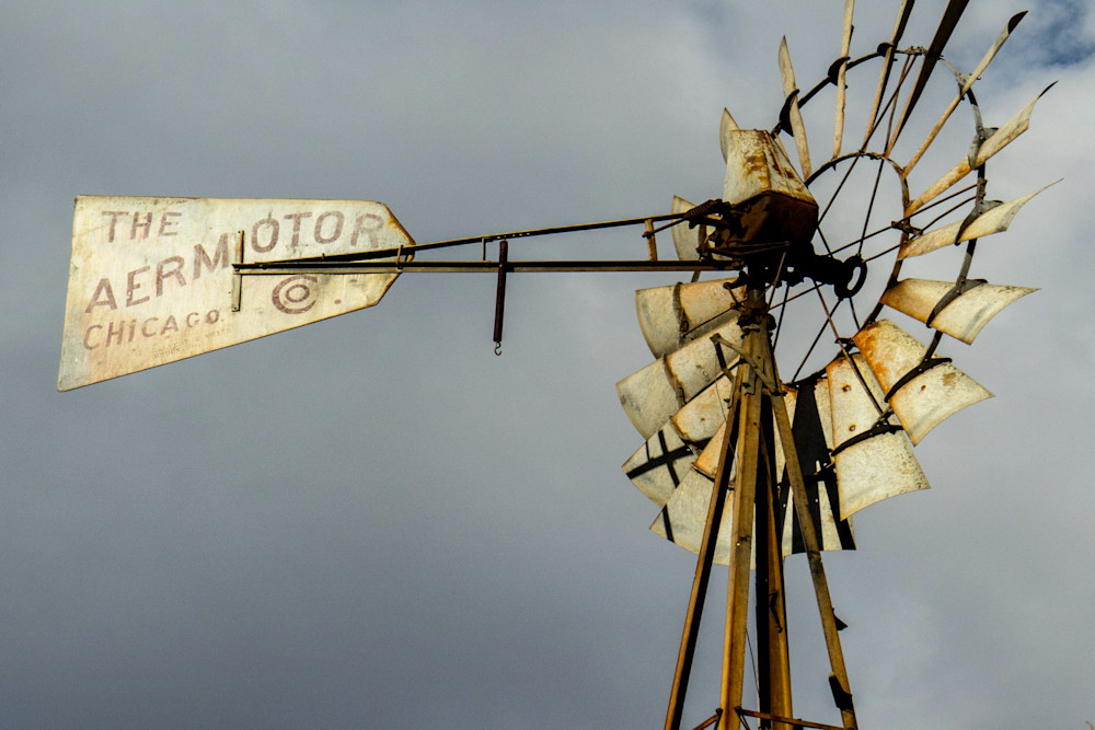 Golden Sun shines on the blades of an Aermotor Windmill