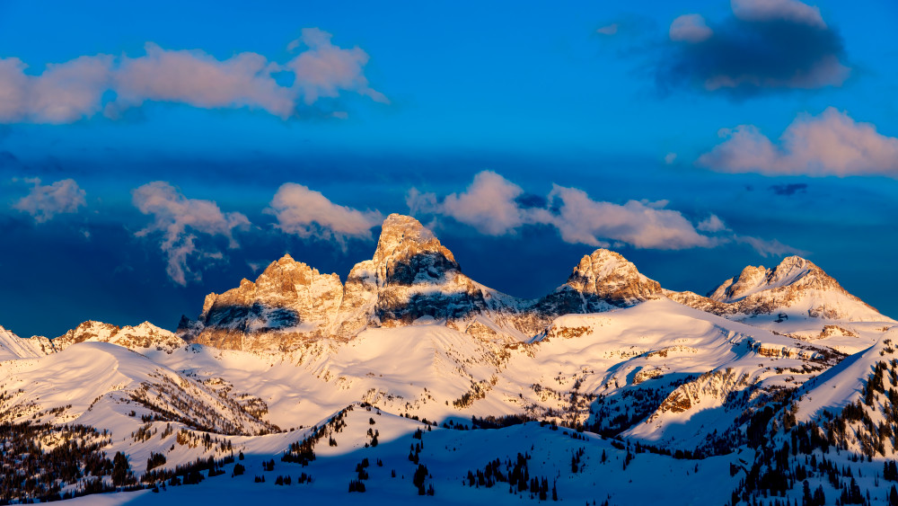 May 8, 2022 - Alta, WY: Looking east at the Teton Mountain Range from the summit of Fred's Mountain and the Grand Targhee Resort, moments before sunset.