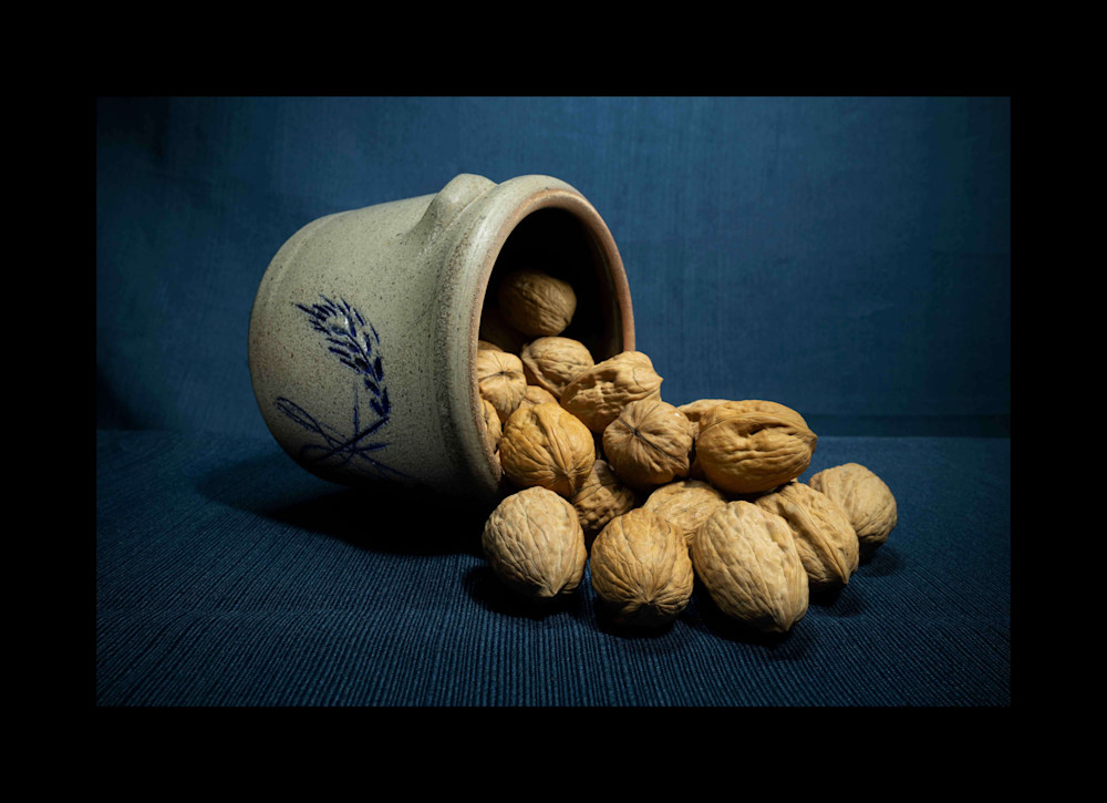 A Fine Art Photograph of Walnuts Flowing from a Bowl