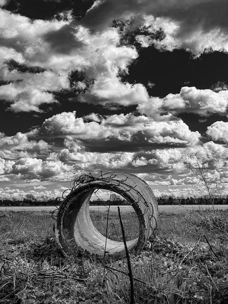 A discarded culvert section rests like a portal to the magical clouds.