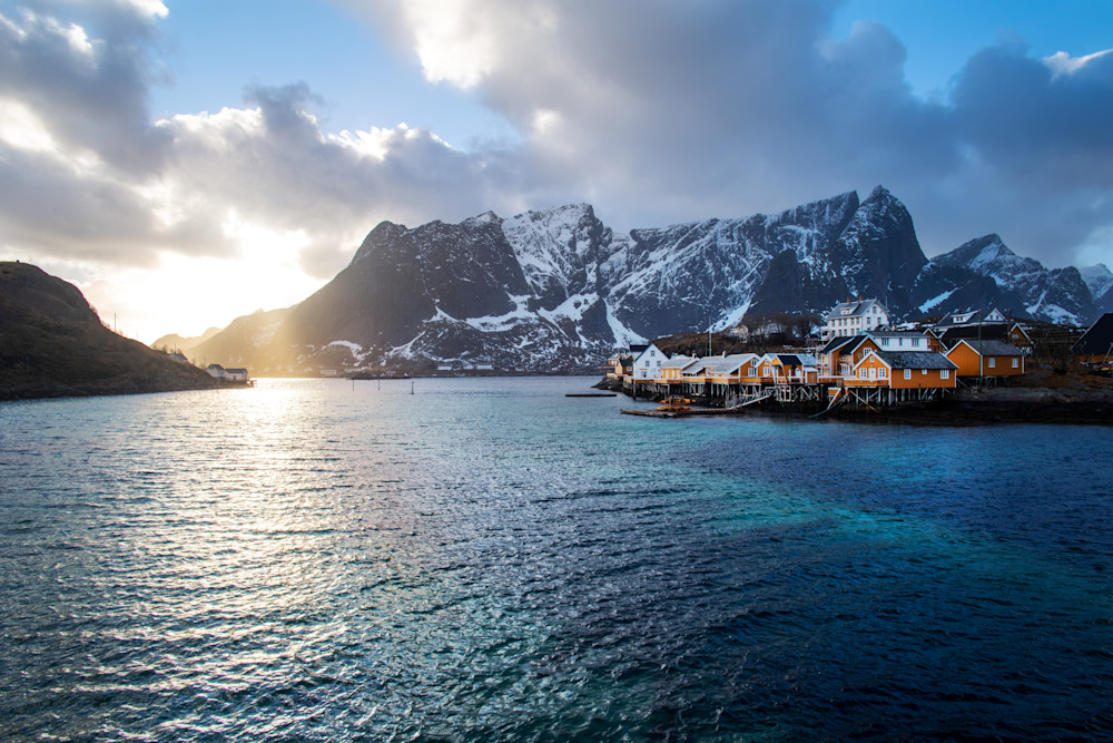 Fishing village in lofoten norway at sunset with fjords in the distance