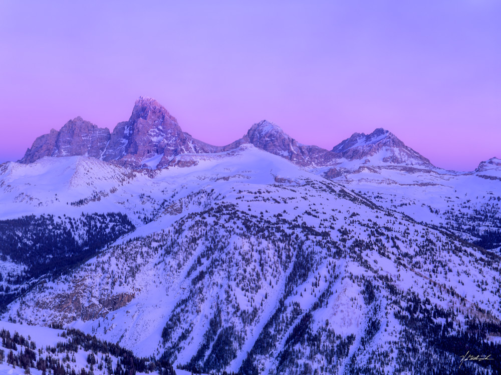 The Teton peaks rise up from snow capped granite mountains in the Targhee National Forest, Teton National Park, Wyoming
