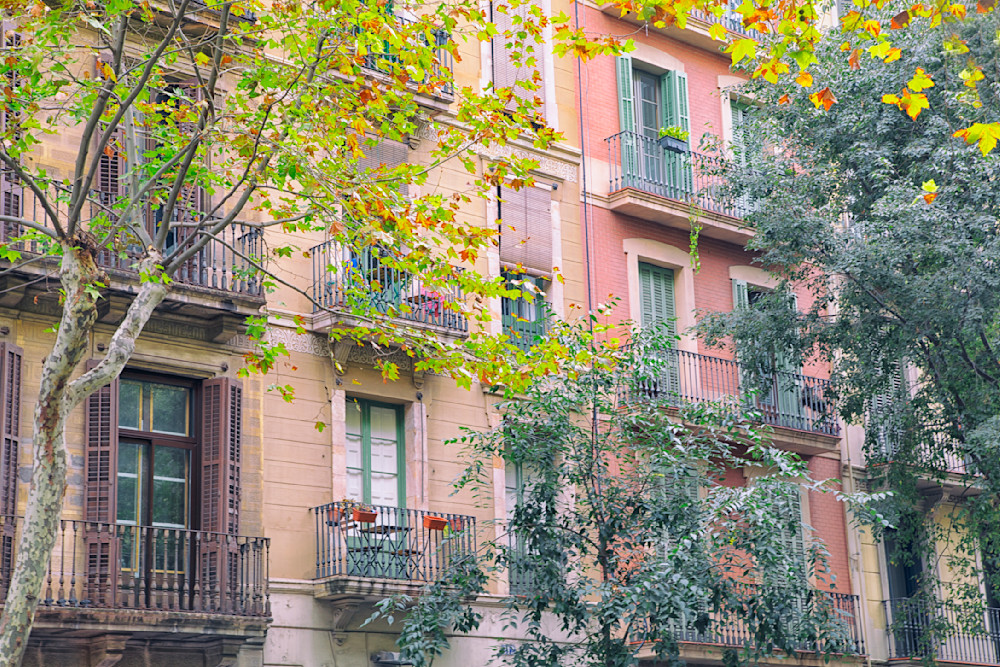 Pink and green buildings in Barcelona, Spain showing traditional architecture and balconies 