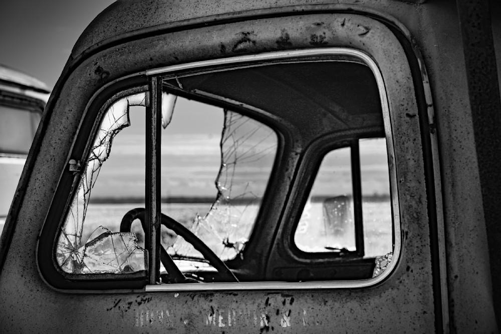 A forlorn truck cab seems to gaze out at the sky through its broken windshield at Carden Ranch.