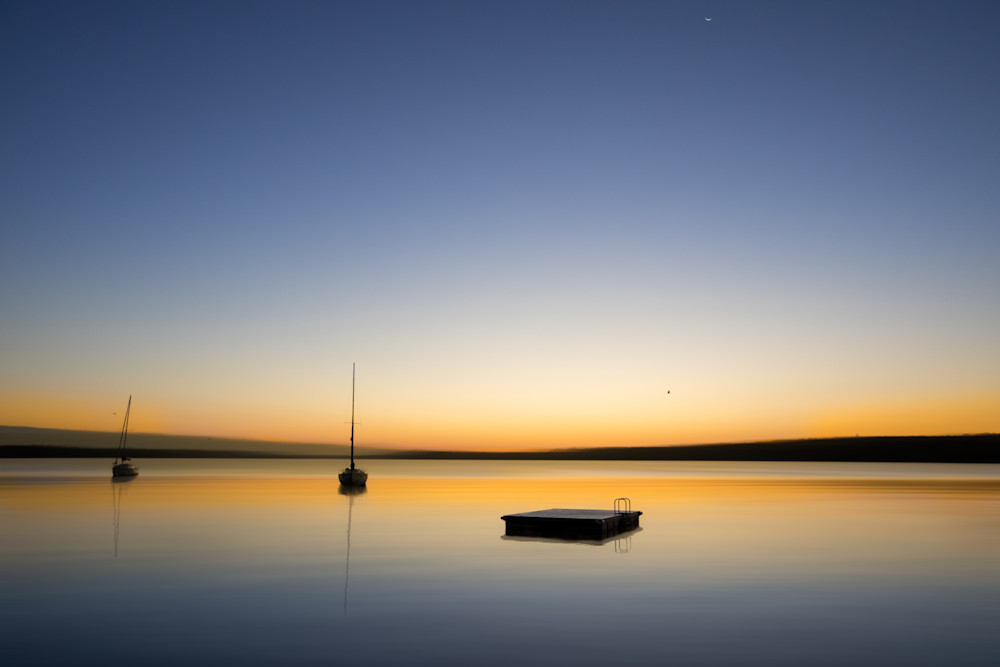 Sunrise Fontana with sailboats and diving platform