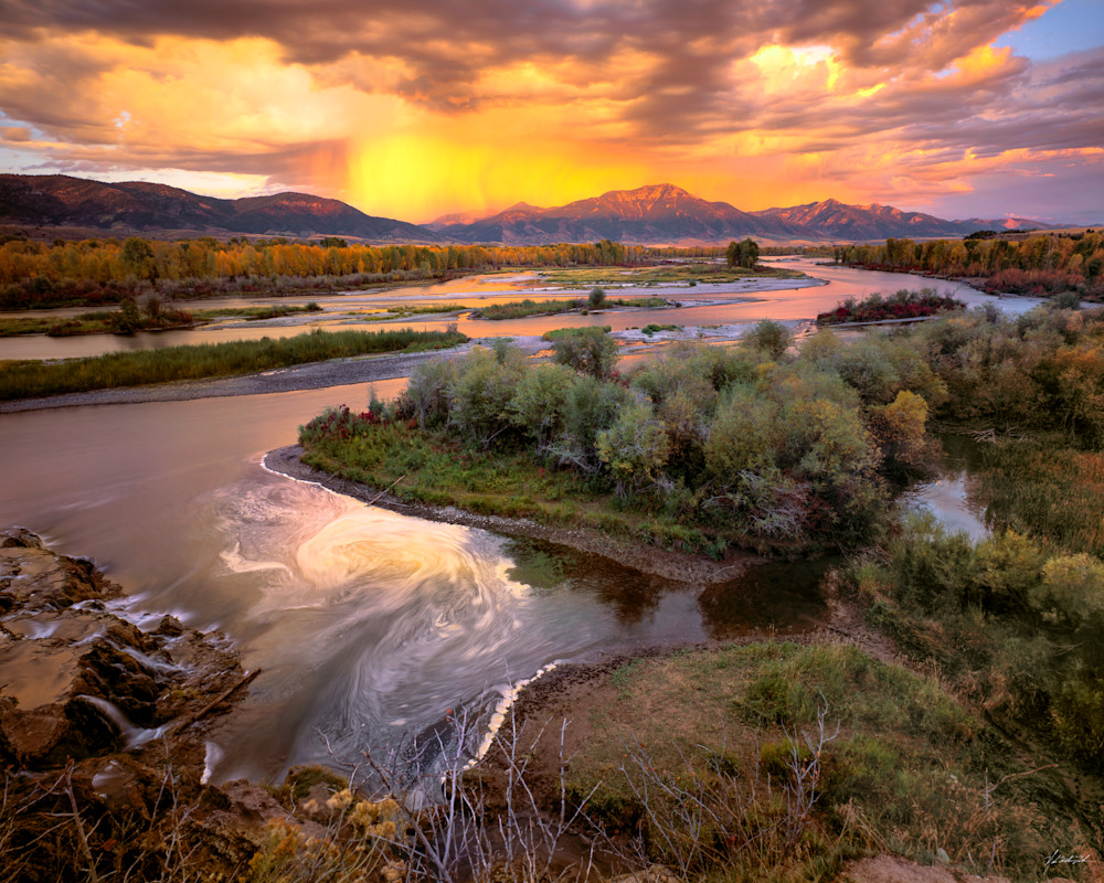 A fall thunder storm illuminates the South Fork of the Snake River in eastern Idaho's Swan Valley.