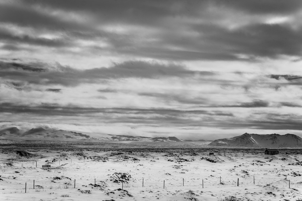 A dramatic black and white photo of a winter landscape in Iceland