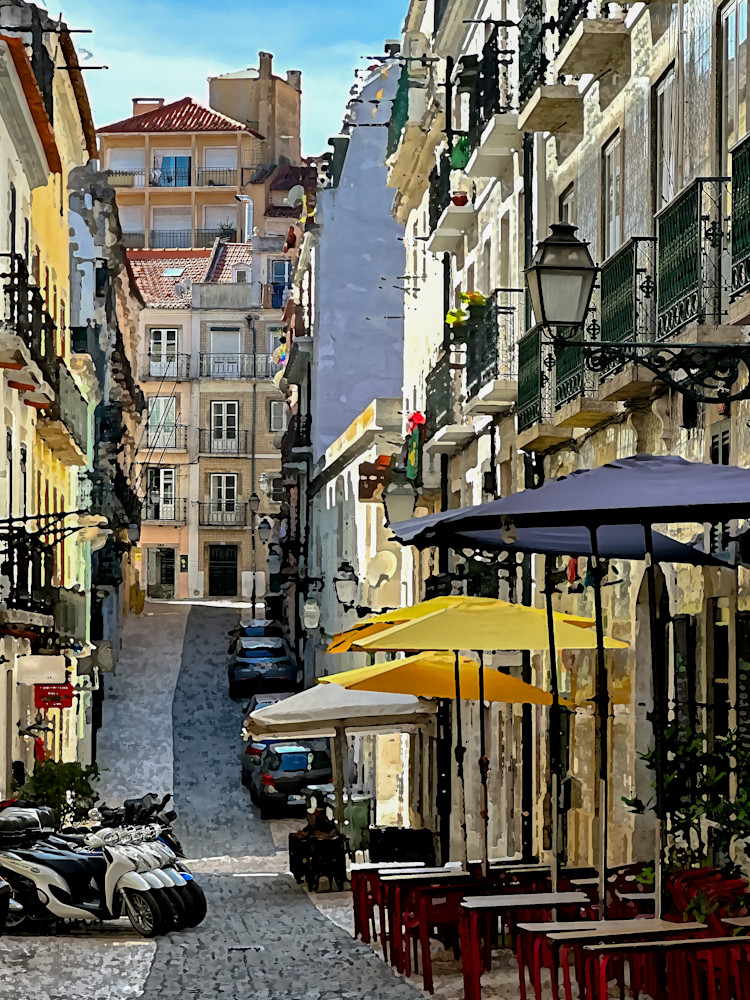 Cafe street scene on shaded Lisbon cobblestone. 