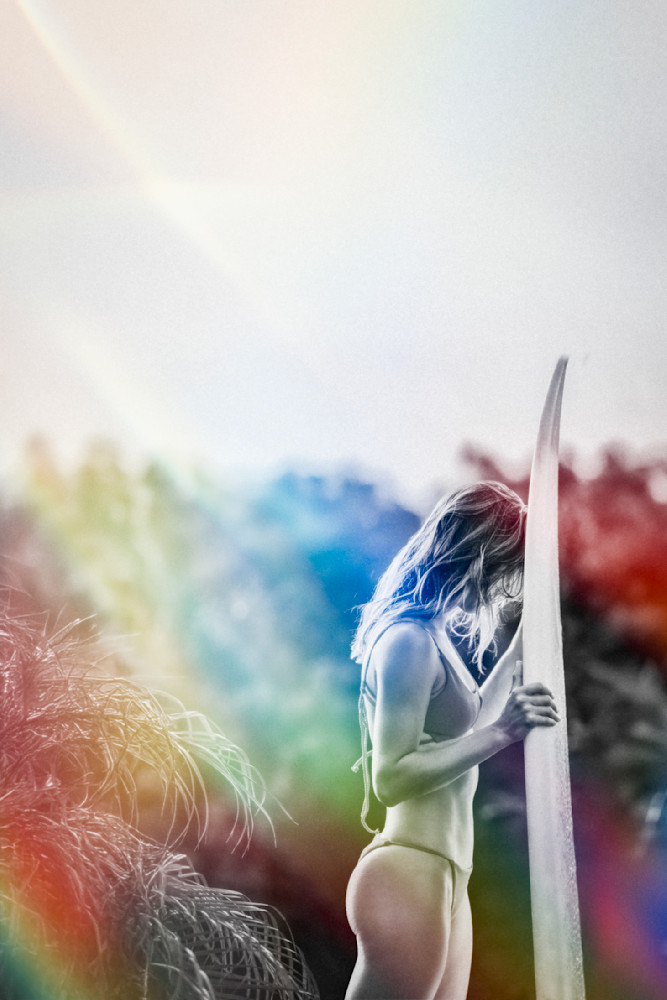 Woman standing peacefully with her favorite surfboard