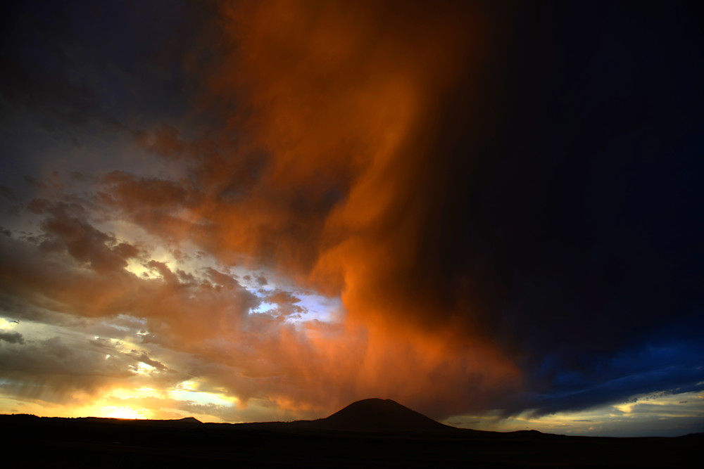 Storm breaks up at sunset over Capulin Volcano in New Mexico, USA.