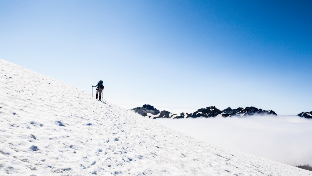 art photography for sale buy artwork online prints for sale woman backpack hiking snowy ridge above the clouds Mount Rainier National Park Washington