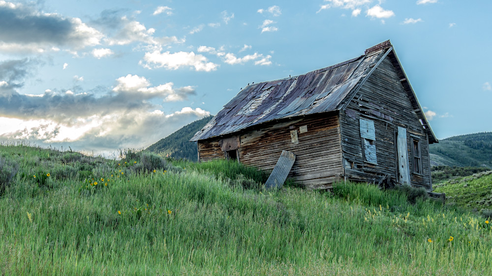 Ranch homestead from over a century ago, showcasing rural architecture amidst a lush landscape