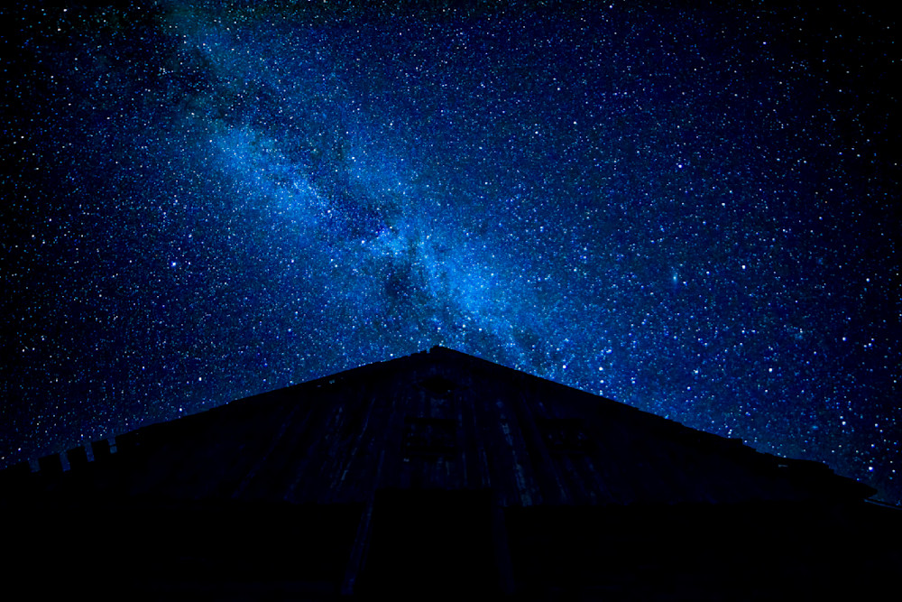 Barn to the stars shows a night sky filled with stars and a silhouette of a barn under the galaxy