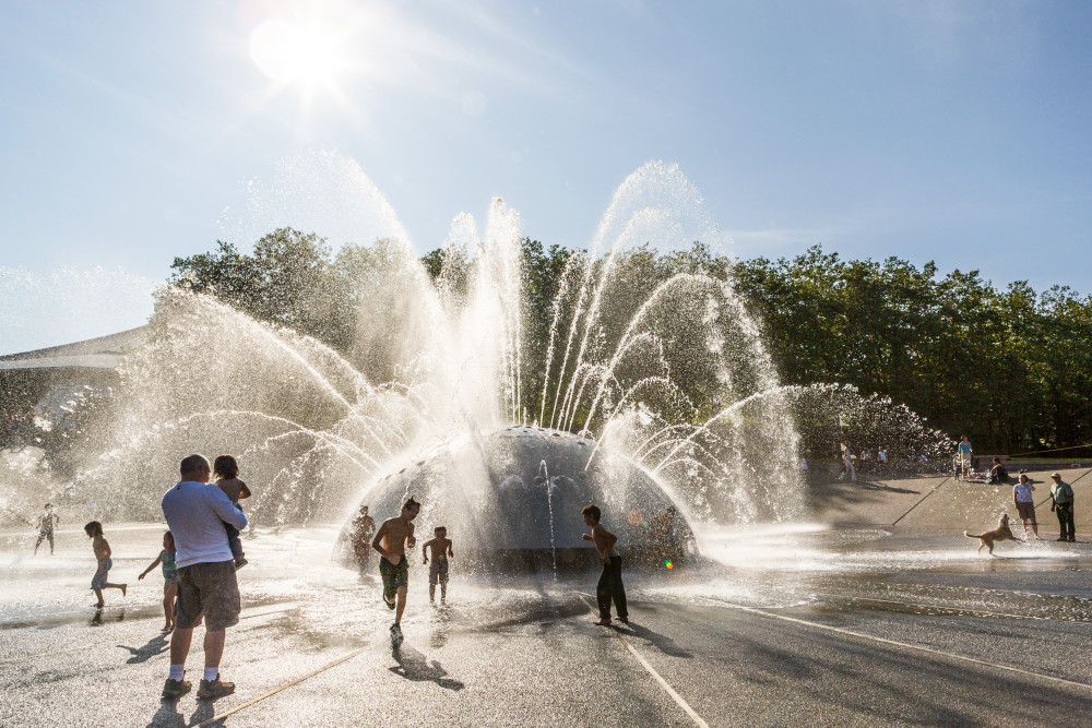 People playing in and around The International Fountain in the Seattle center, Seattle, WA, USA.