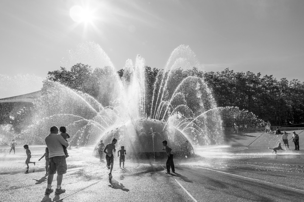 People playing in and around The International Fountain in the Seattle center, Seattle, WA, USA.