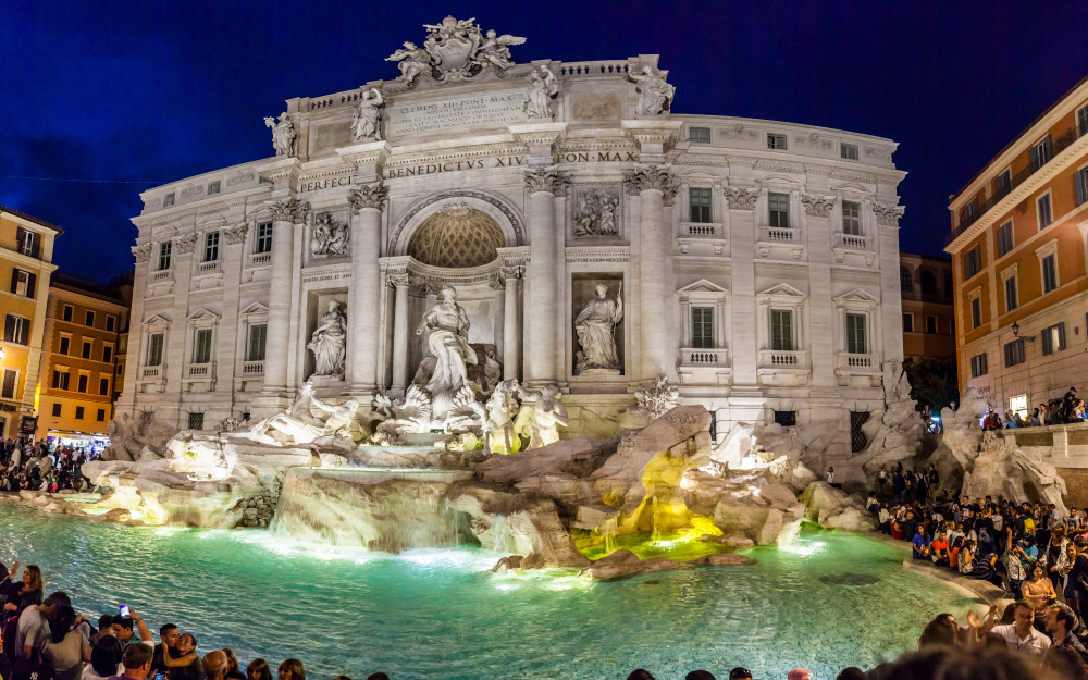 The Trevi Fountain in Rome Italy at night.