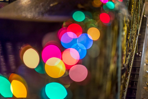 A string of holiday lights along the railing of a patio cafe