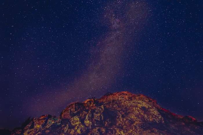 The Milky Way over a graffiti mountain