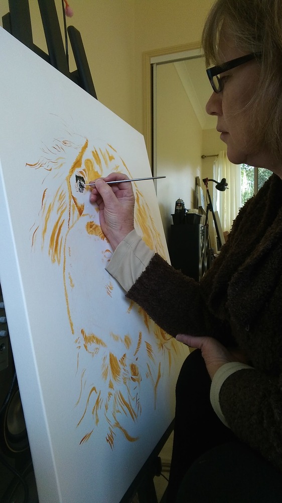 Sonia the artist painting an orange Golden Retriever dog on a large canvas