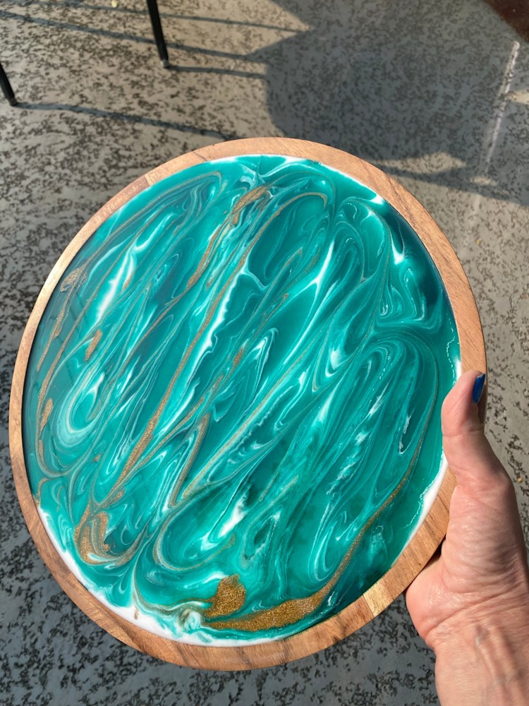 Green and gold swirl wooden round platter 12 inch outdoors view