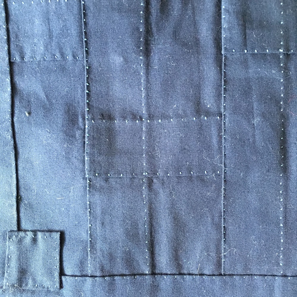 Close up of Namu Kie Butsu stitches on rakusu