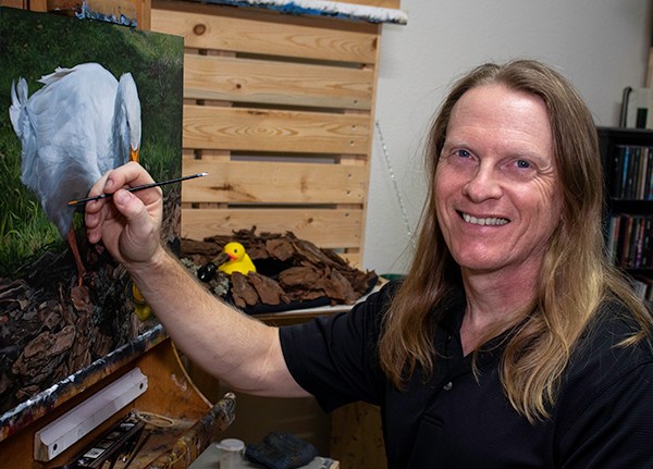 Florida artist Kevin Grass painting one of his "Lame Ducks" paintings in his studio