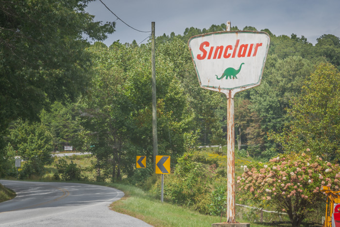 An old Sinclair Oil sign along the road