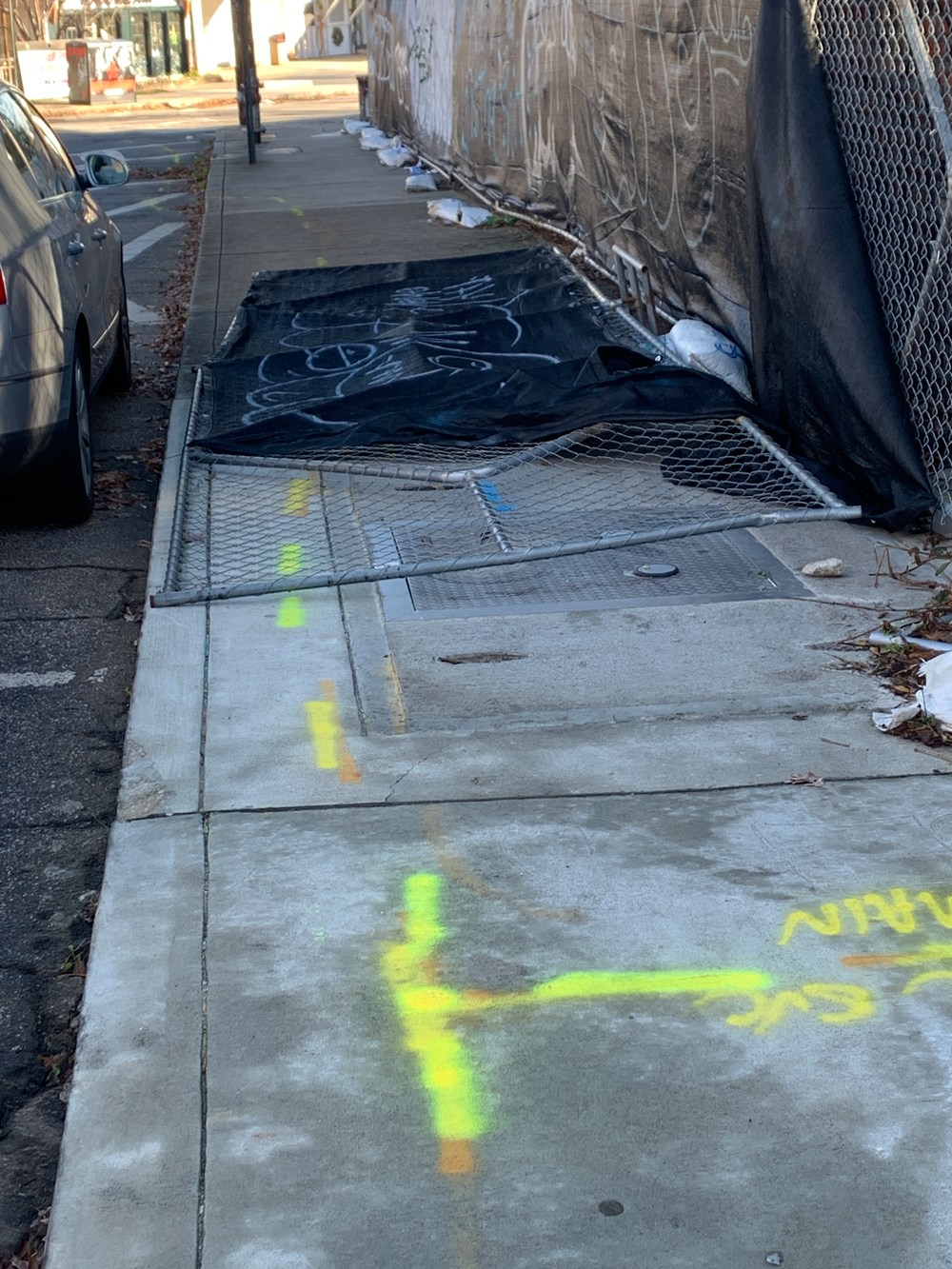 Chainlink fence fallen across the sidewalk in Atlanta