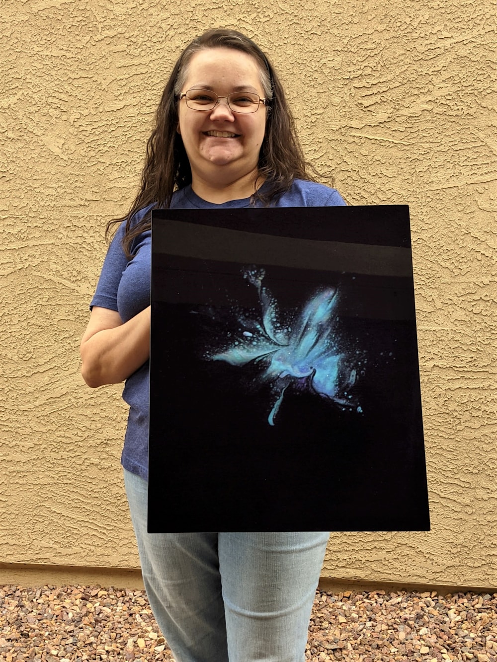 Kristin Dragos holding a print of "Fairy Dust".
