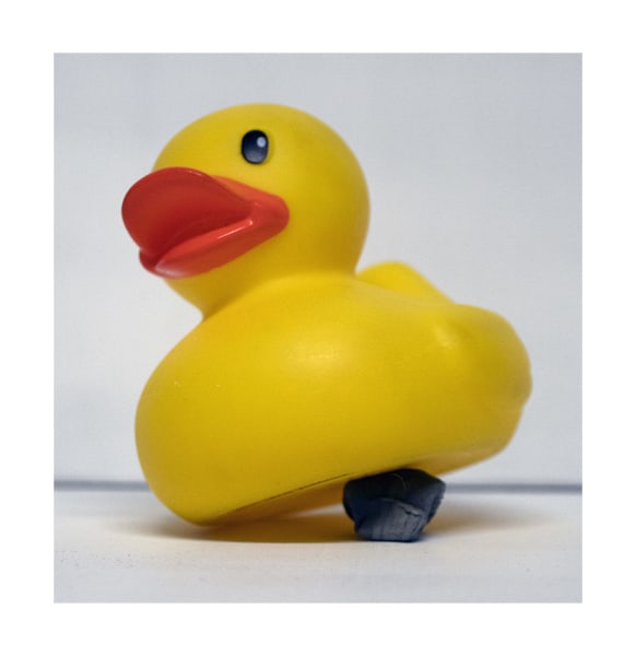 a rubber duck sitting on a kneaded eraser