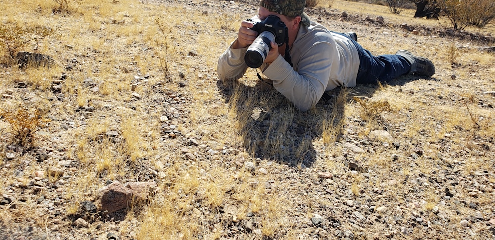 Nature photographer Thomas Watkins photographing a Horned Toad Lizard in the Arizona desert.