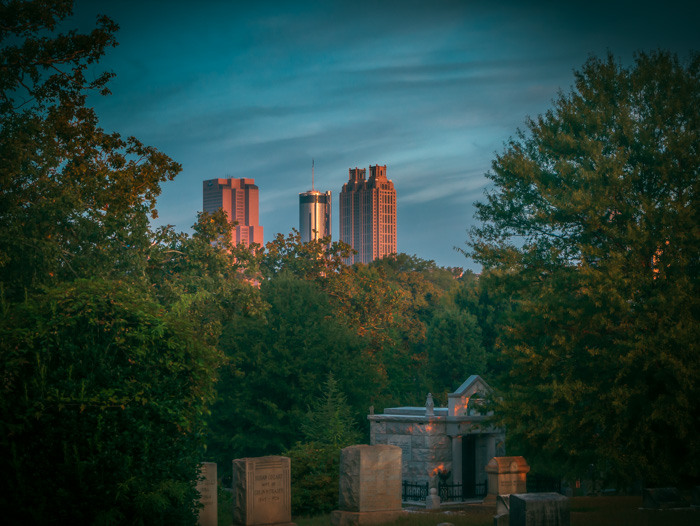 Atlanta buildings with cemetery in the foreground with a cinematic (turquoise and red) edit