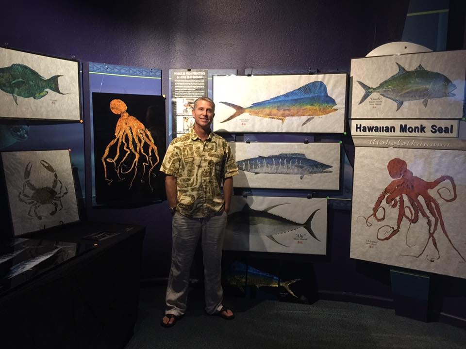 Owner Brian Heustis with selections of his work