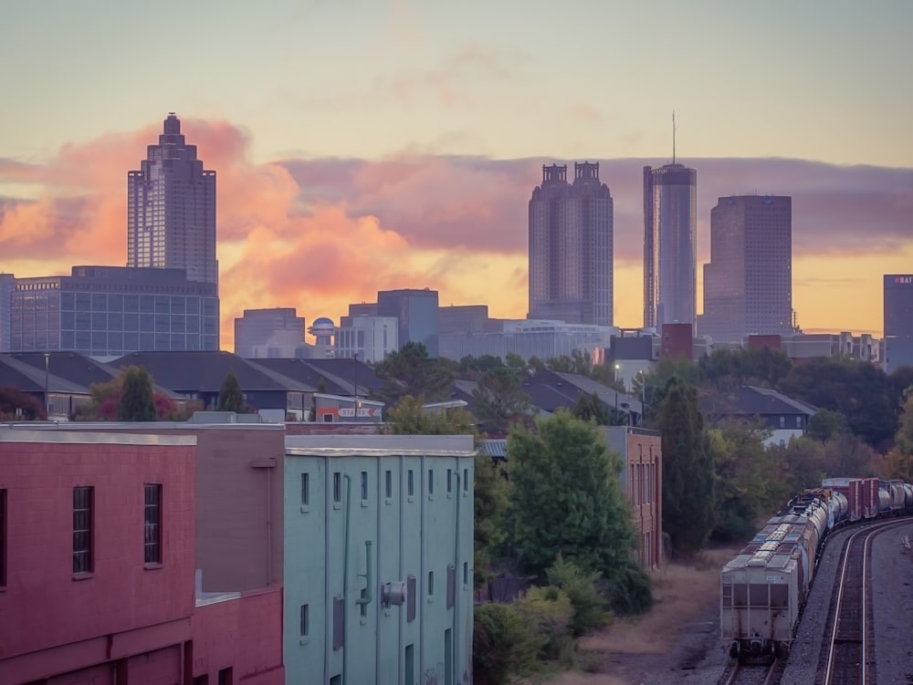A beautiful sunrise with the City of Atlanta in the background and train tracks in the foreground