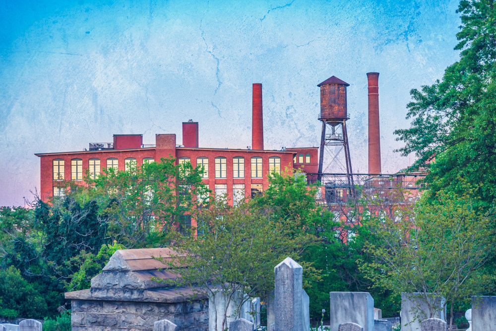 A creative edit of the view of a water tower and smokestacks behind Oakland Cemetery in Atlanta