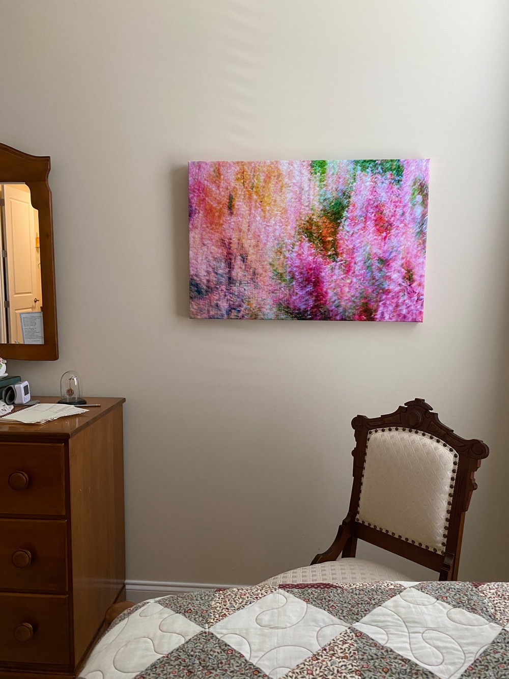 Photo of an abstract photo printed on canvas hanging in a room.