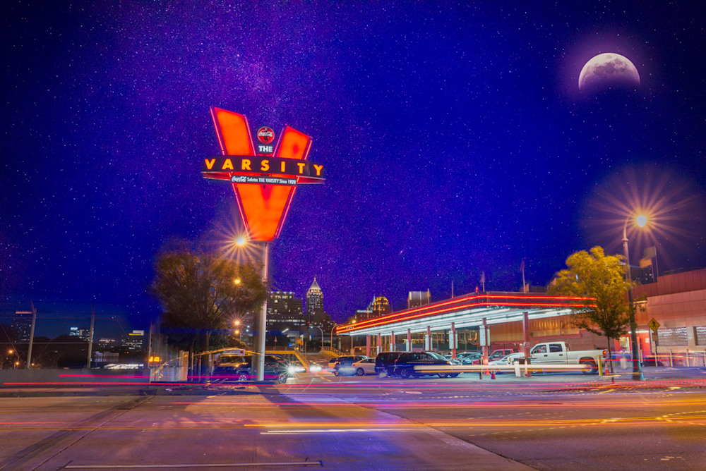 A fine-art composite photo of the Varsity in Atlanta with a Milky Way sky and the moon