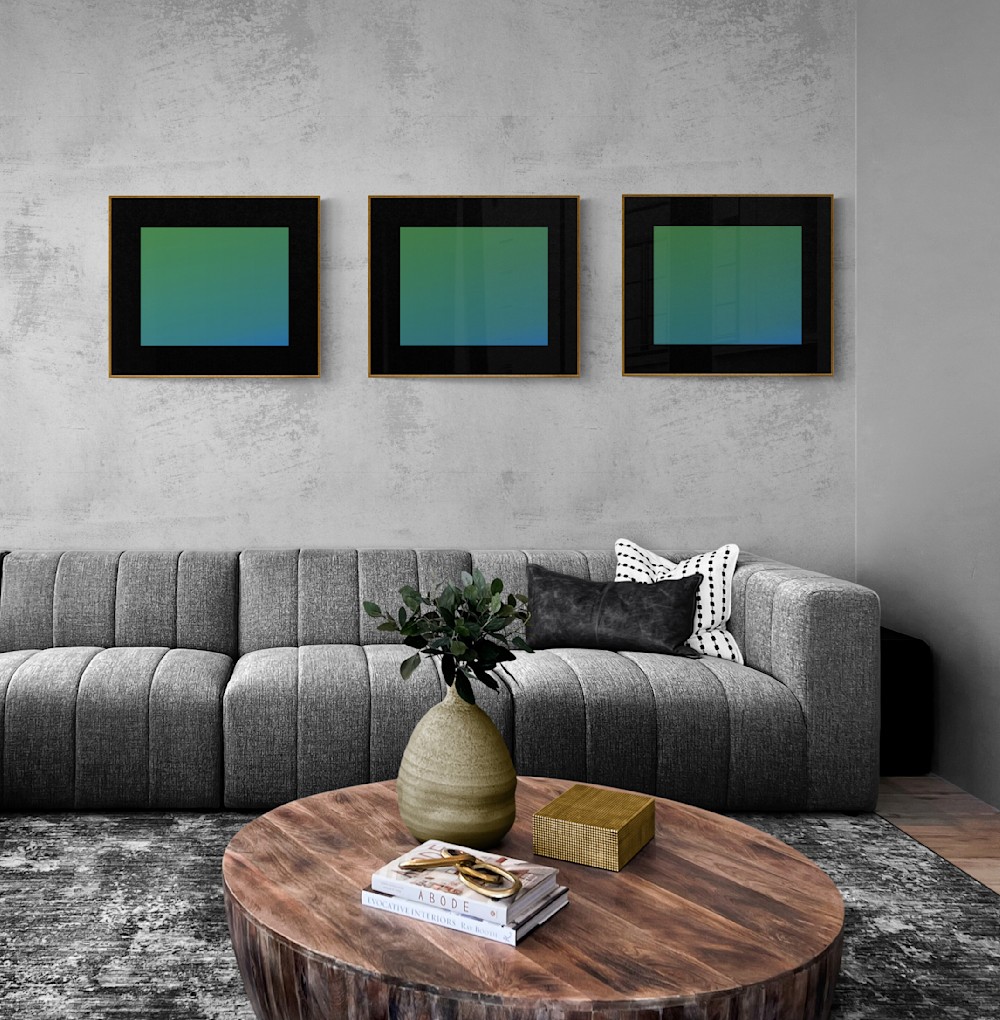 A grouping of three art pieces that are each framed the same way.