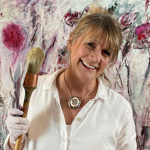 photo of Dawn Boyer in front of one of her paintings