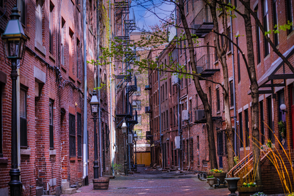  A photo of a street lined with red brick buildings.