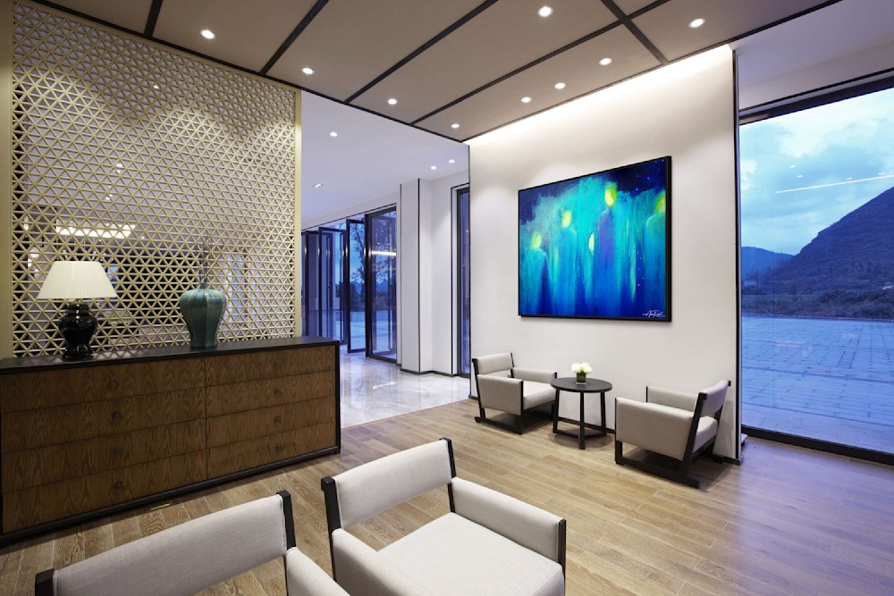 Abstract blue angelic artwork in modern hotel lobby with mountain view