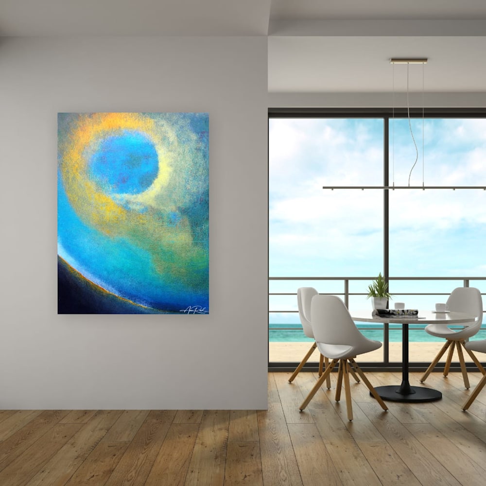 Abstract blue and gold art print in modern oceanview dining room with natural light