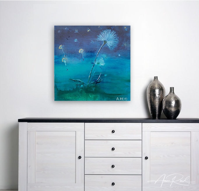 Light and Momentary, print – Tranquil Dandelion Art for Minimalist Interiors: Abstract expressionist painting by colourist Anne Reid Artist featuring glowing dandelion seeds floating above teal-blue water on a white wall above a minimalist dresser